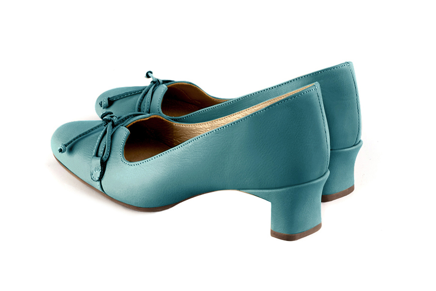 French elegance and refinement for these turquoise blue dress pumps, with a knot on the front, 
                available in many subtle leather and colour combinations. With its original cut, this pretty low-heeled pump
will serve you well, combining comfort and distinction. 
                Matching clutches for parties, ceremonies and weddings.   
                You can customize these shoes to perfectly match your tastes or needs, and have a unique model.  
                Choice of leathers, colours, knots and heels. 
                Wide range of materials and shades carefully chosen.  
                Rich collection of flat, low, mid and high heels.  
                Small and large shoe sizes - Florence KOOIJMAN